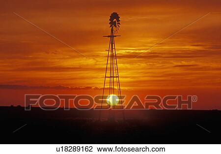Stock Image - Windmill at sunset in Forgan. Fotosearch