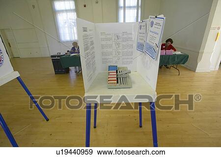 Election volunteers and voting booths in a polling place View Large Photo Image Stock Photo - Election volunteers and voting booths in a polling place. Fotosearch