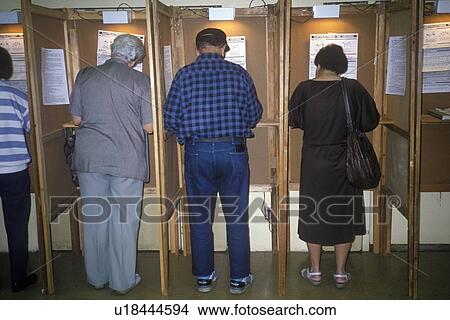 Picture - Voters and voting booths in a polling place. Fotosearch