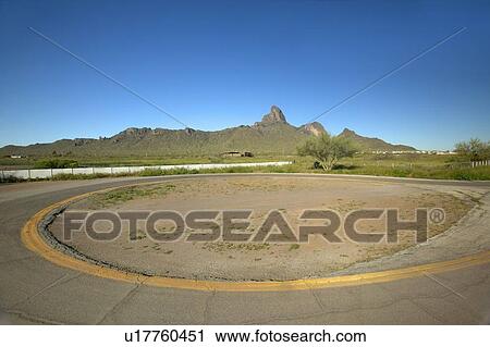 Stock Image - Empty circular drive in the desert near Picacho Peak State Park. Fotosearch