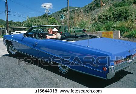 A couple in a blue Buick Electra convertible View Large Photo Image Stock Photo - A couple in a blue Buick Electra convertible. Fotosearch