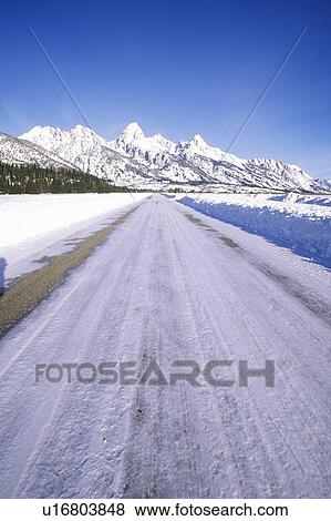 Stock Photo - Winter Road To Grand Tetons, Jackson, Wyoming. Fotosearch