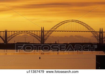 Stock Photo - The Yaquina Bay Bridge at sunset . Fotosearch