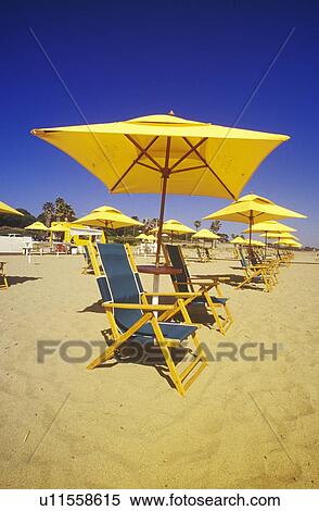 Stock Photography - Yellow Umbrellas and Beach Chairs. Fotosearch