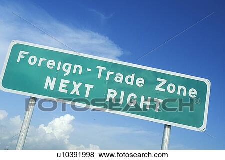 Stock Photo - A sign that reads “Foreign trade zone next right”. Fotosearch