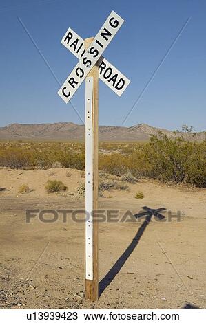 Stock Image - Railroad crossing sign and intersection. Fotosearch