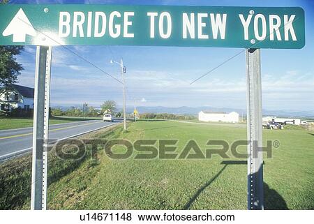 Stock Photo - A sign that reads “Bridge to New York”. Fotosearch