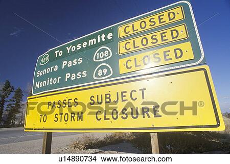 A sign that reads “Passes subject to storm closure” View Large Photo Image Picture - A sign that reads “Passes subject to storm closure”. Fotosearch
