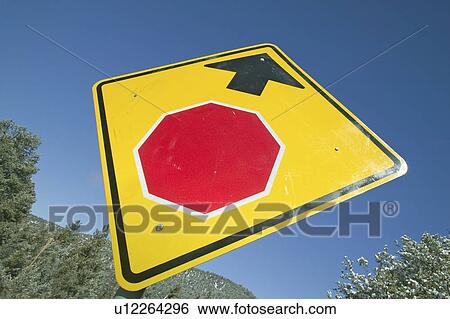 Stock Photograph - Close up of yellow sign reading stop ahead. Fotosearch