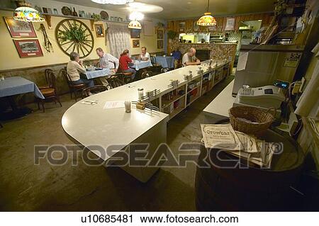 Stock Image - Restaurant interior with diners eating. Fotosearch