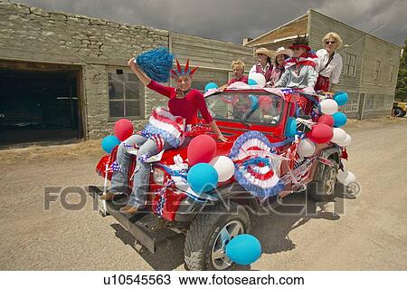 Teenagers riding a jeep decorated for the Fourth of July View Large Photo Image Stock Image - Teenagers riding a jeep decorated for the Fourth of July. Fotosearch