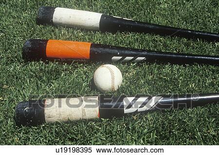 Stock Photography - Baseball bats and ball on field. Fotosearch