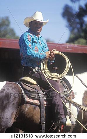 Portrait of cowboy on horseback with lasso View Large Photo Image Stock Image - Portrait of cowboy on horseback with lasso. Fotosearch