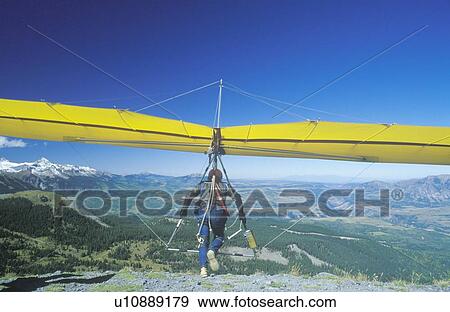 Stock Photo - Rear view of Hang Glider taking off of cliff. Fotosearch