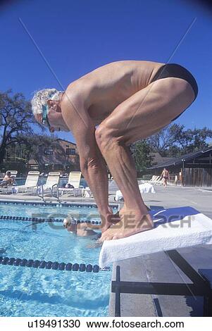 Senior Olympic Swimming competition, Man at starting gate View Large Photo Image Stock Image - Senior Olympic Swimming competition, Man at starting gate. Fotosearch