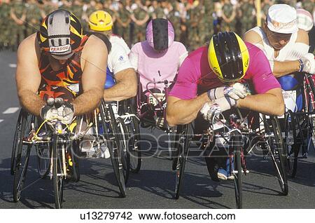 Stock Image - Wheelchair athletes at start line of marathon run. Fotosearch