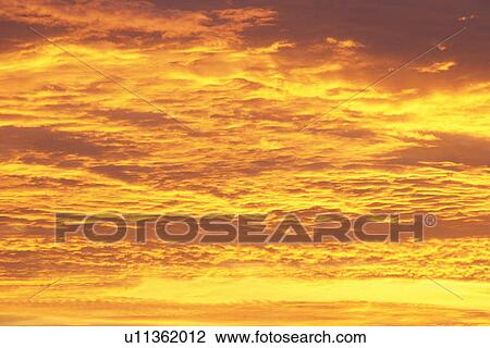 Stock Image - Clouds at Sunset. Fotosearch