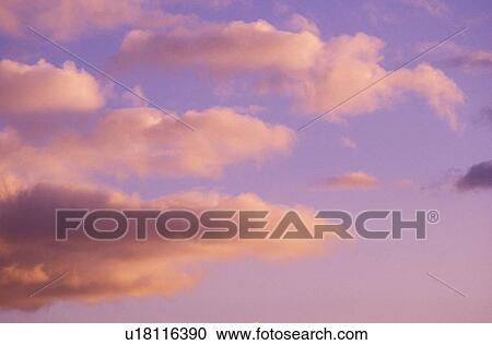 Stock Image - Clouds at Sunset. Fotosearch