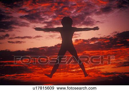 Sunset sky behind silhouette of New Age Man View Large Photo Image Stock Photo - Sunset sky behind silhouette of New Age Man. Fotosearch