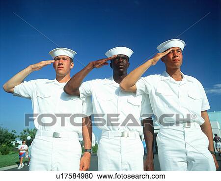 Stock Image - Ethnically diverse trio of sailors saluting. Fotosearch