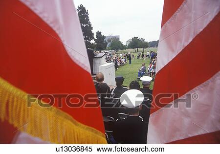 Stock Photography - Veteran's Day Ceremony Glimpsed Through Flags, Veteran's National Cemetery. Fotosearch