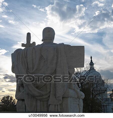 Stock Photograph - Back view of Authority of Law sculpture in front of Supreme Court building with in Washington D. C.. Fotosearch