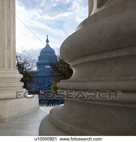 View of Capitol building in distance from behind columns of the Supreme Court building in Washington D. C. View Large Photo Image Stock Image - View of Capitol building in distance from behind columns of the Supreme Court building in Washington D. C.. Fotosearch