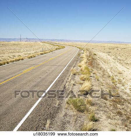 Road through barren landscape in Utah. View Large Photo Image Stock Photo - Road through barren landscape in Utah.. Fotosearch