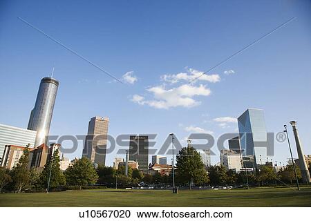 Stock Image - Skyline behind Centennial Olympic Park in downtown Atlanta, Georgia.. Fotosearch