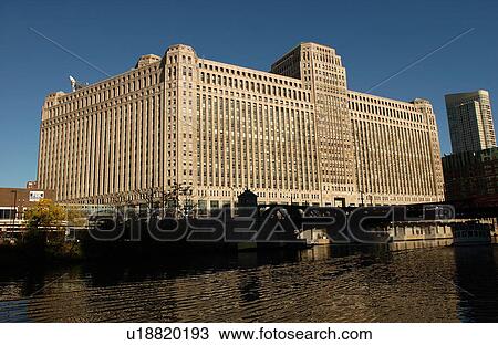 Stock Image - Merchandise Mart on the banks of a river in Chicago. Fotosearch