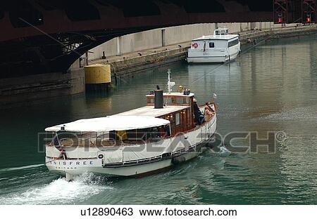 Motorboat passing under a bridge View Large Photo Image Stock Image - Motorboat passing under a bridge. Fotosearch
