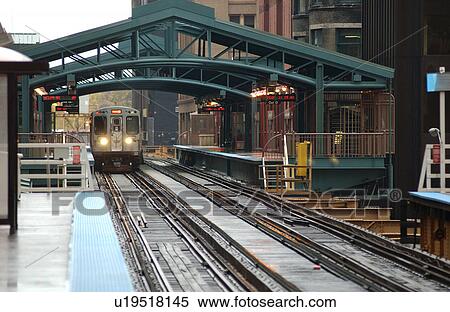 Stock Photography - Train moving on the tracks at CTA Station in Chicago. Fotosearch