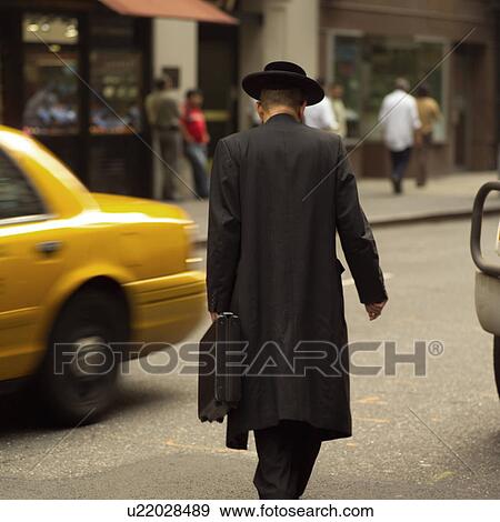 Stock Photo - Man walking down street, New York City. Fotosearch