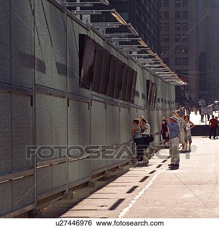 Tourists at the barrier surrounding the World Trade Center site, New York City View Large Photo Image Stock Photograph - Tourists at the barrier surrounding the World Trade Center site, New York City. Fotosearch