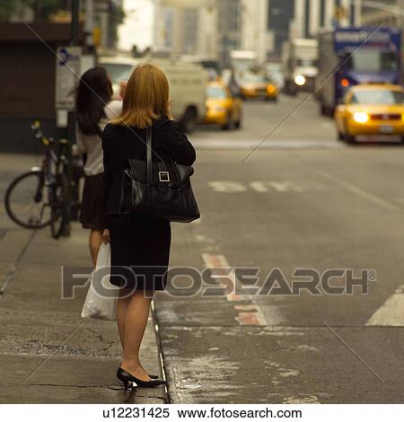 Woman standing at curb, New York City View Large Photo Image Stock Photography - Woman standing at curb, New York City. Fotosearch