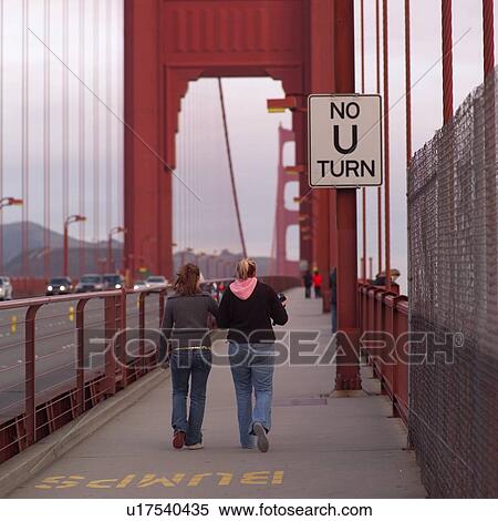 Stock Photography - Women walking over Golden Gate Bridge. Fotosearch