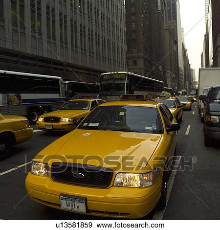 Yellow taxis and buses in traffic, New York City View Large Photo Image Stock Photo - Yellow taxis and buses in traffic, New York City. Fotosearch