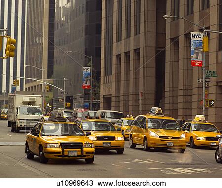 Stock Image - Yellow taxis in traffic, New York City. Fotosearch