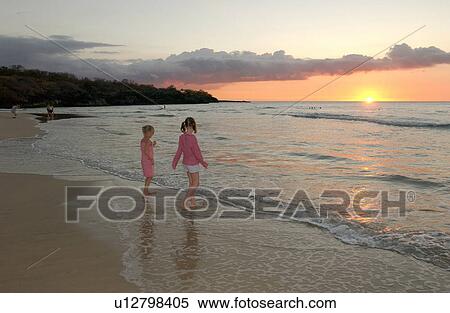 Stock Photography - Kids playing on beach - Hawaii. Fotosearch