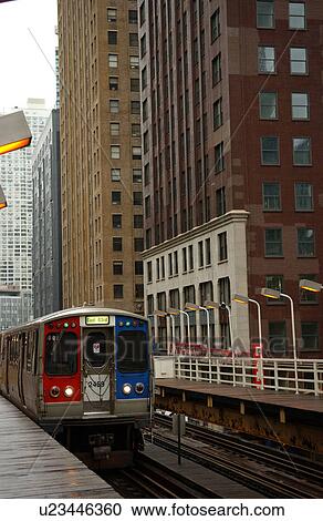 Stock Image - Train moving on the tracks at CTA Station in Chicago. Fotosearch