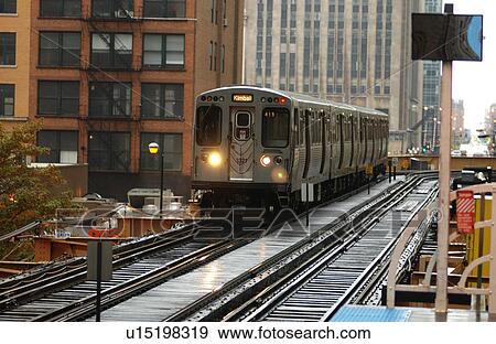 Stock Photo - Train moving on the tracks at CTA Station in Chicago. Fotosearch