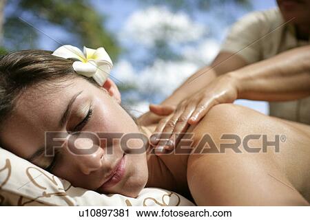A massager massaging a young woman’s back. View Large Photo Image Stock Image - A massager massaging a young woman’s back.. Fotosearch