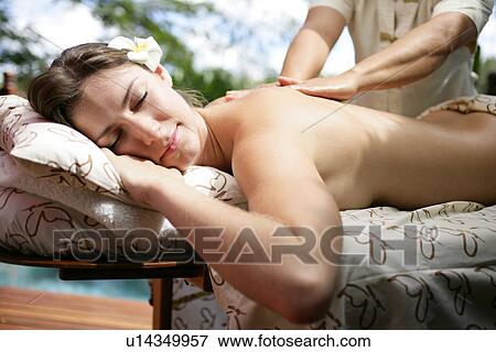 A massager massaging a young woman’s back. View Large Photo Image Stock Photo - A massager massaging a young woman’s back.. Fotosearch