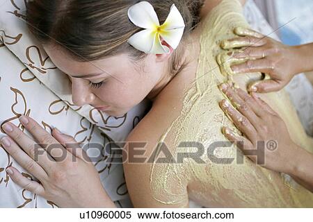 A person applying cream on a young woman’s back. View Large Photo Image Stock Photography - A person applying cream on a young woman’s back.. Fotosearch
