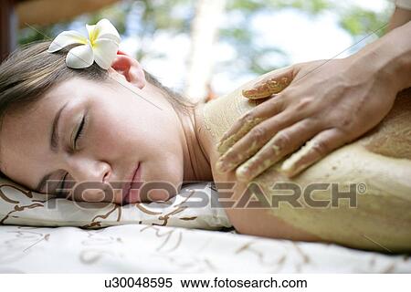 A person applying cream on a young woman’s back. View Large Photo Image Stock Photography - A person applying cream on a young woman’s back.. Fotosearch