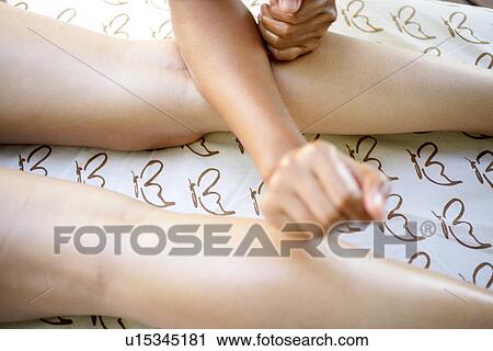A person massaging a woman’s leg. View Large Photo Image Stock Image - A person massaging a woman’s leg.. Fotosearch