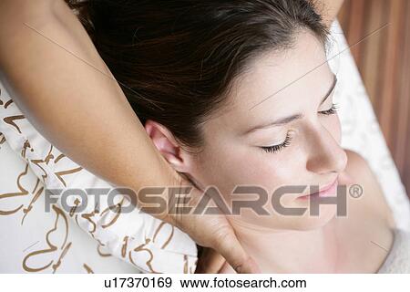 A person massaging a young woman. View Large Photo Image Stock Photo - A person massaging a young woman.. Fotosearch