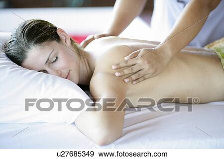 A person massaging a young woman’s back. View Large Photo Image Stock Photo - A person massaging a young woman’s back.. Fotosearch