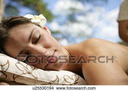Picture - A seminude woman resting on a pillow.. Fotosearch