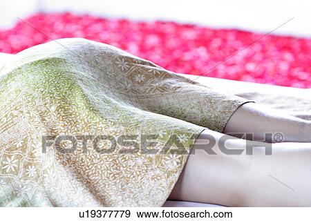 A woman lying on massage table. View Large Photo Image Stock Photo - A woman lying on massage table.. Fotosearch